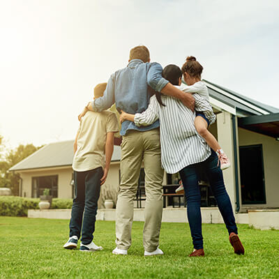 family in front of their new home